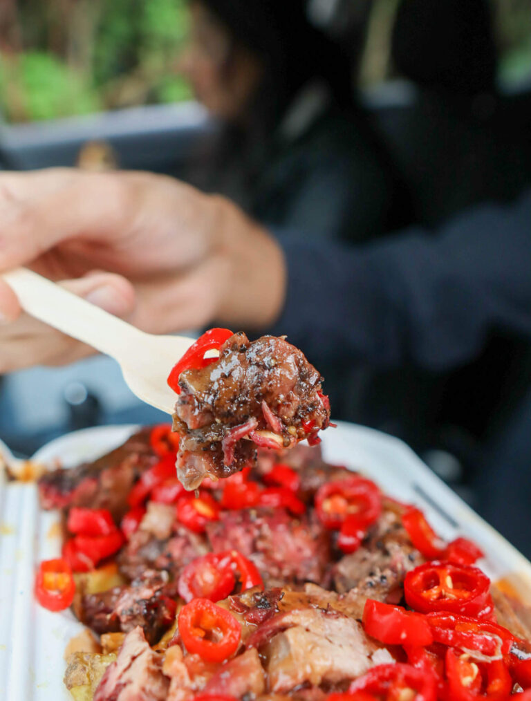 spoon with loaded meat and chillies on it